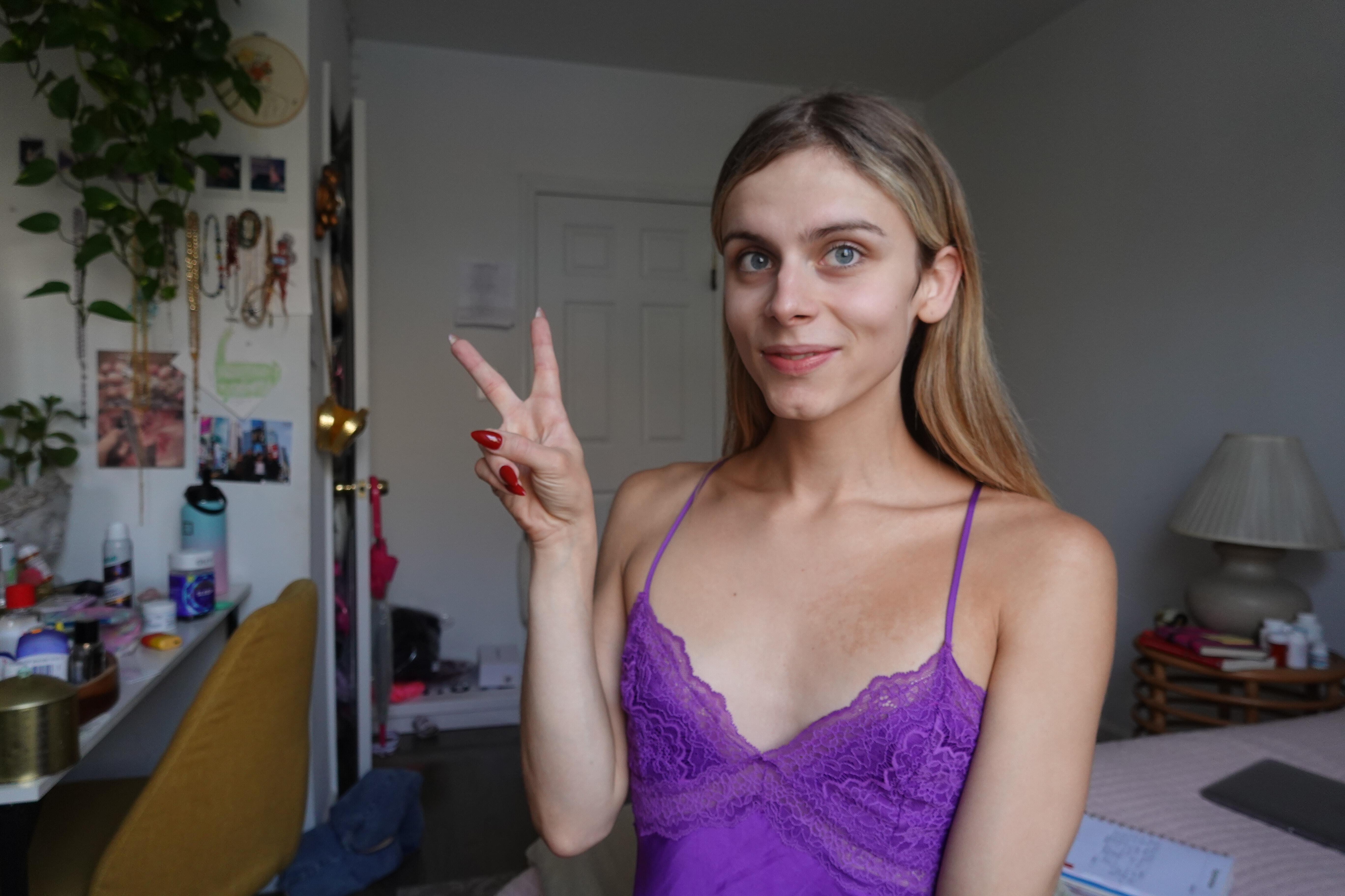 blonde trans girl showing peace sign