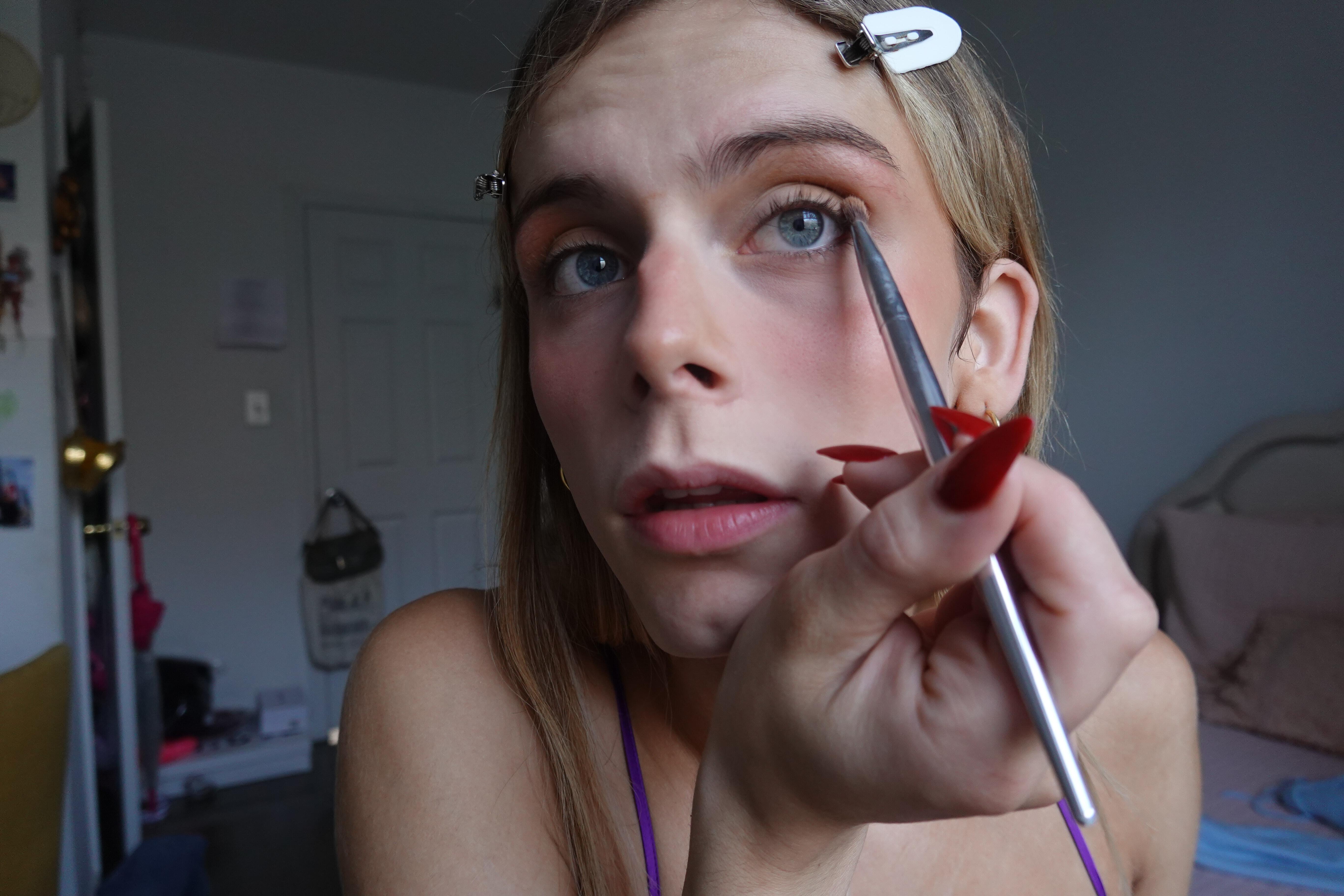 blonde girl applying eyeshadow