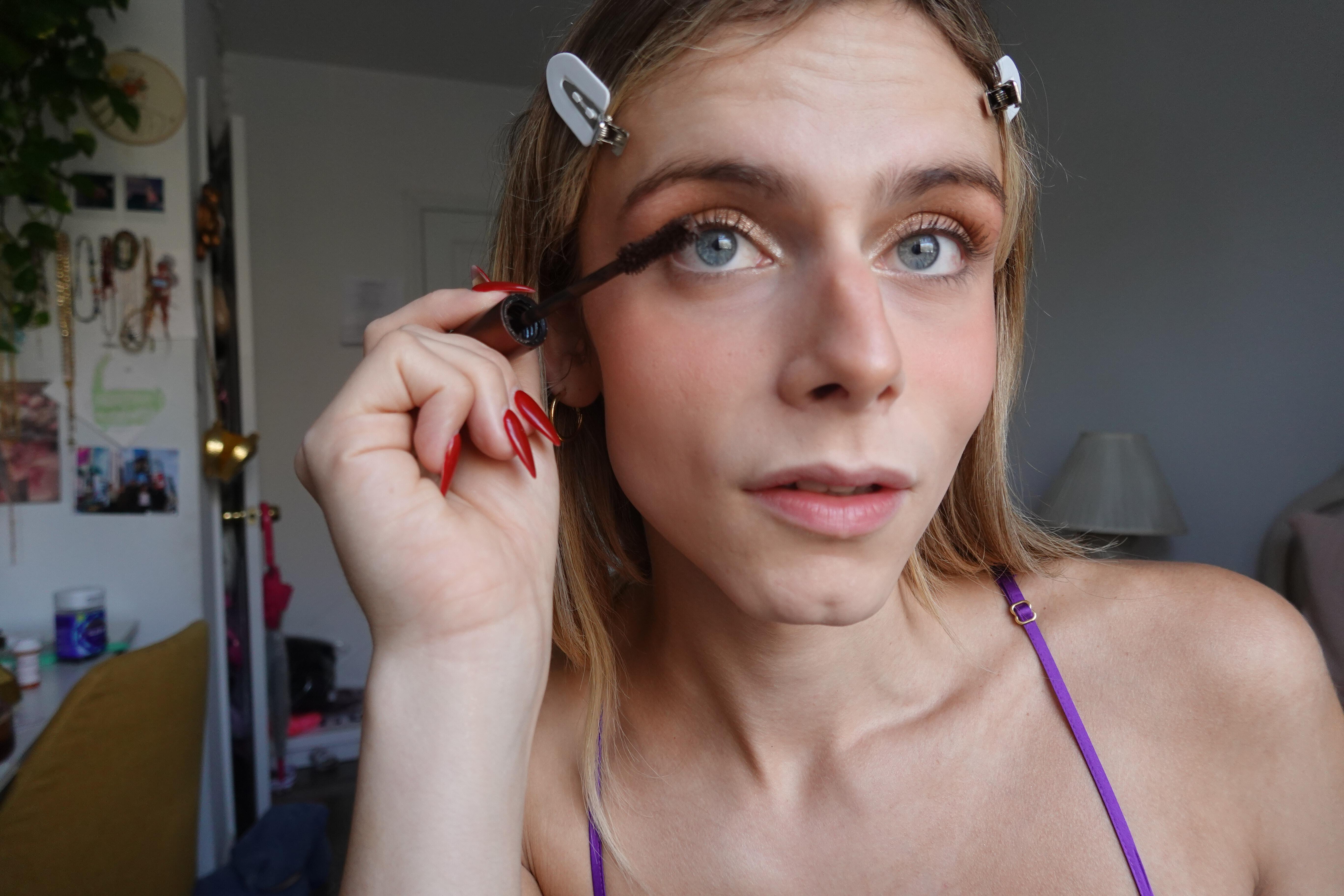 trans girl putting on mascara