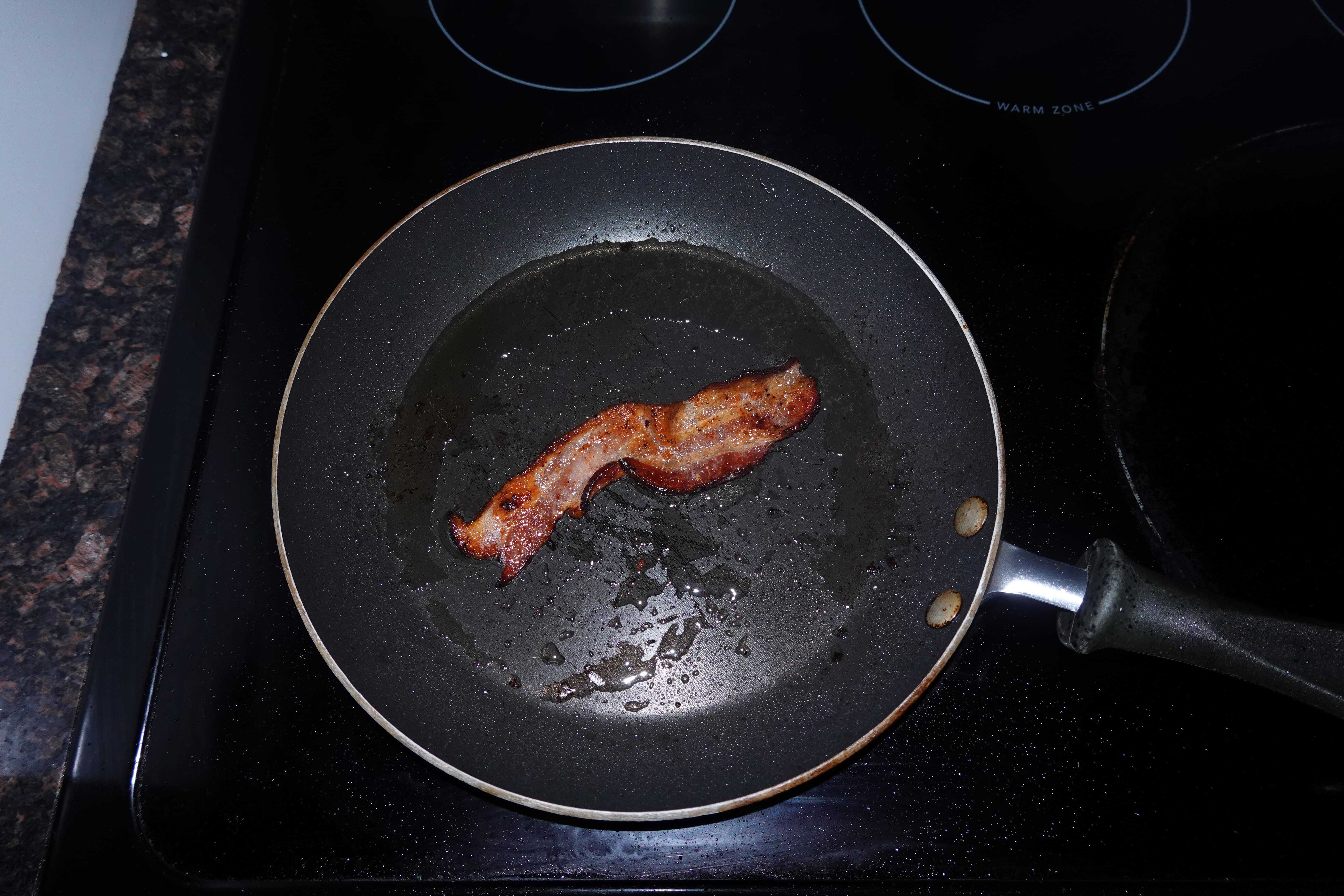 frying bacon in a saucepan