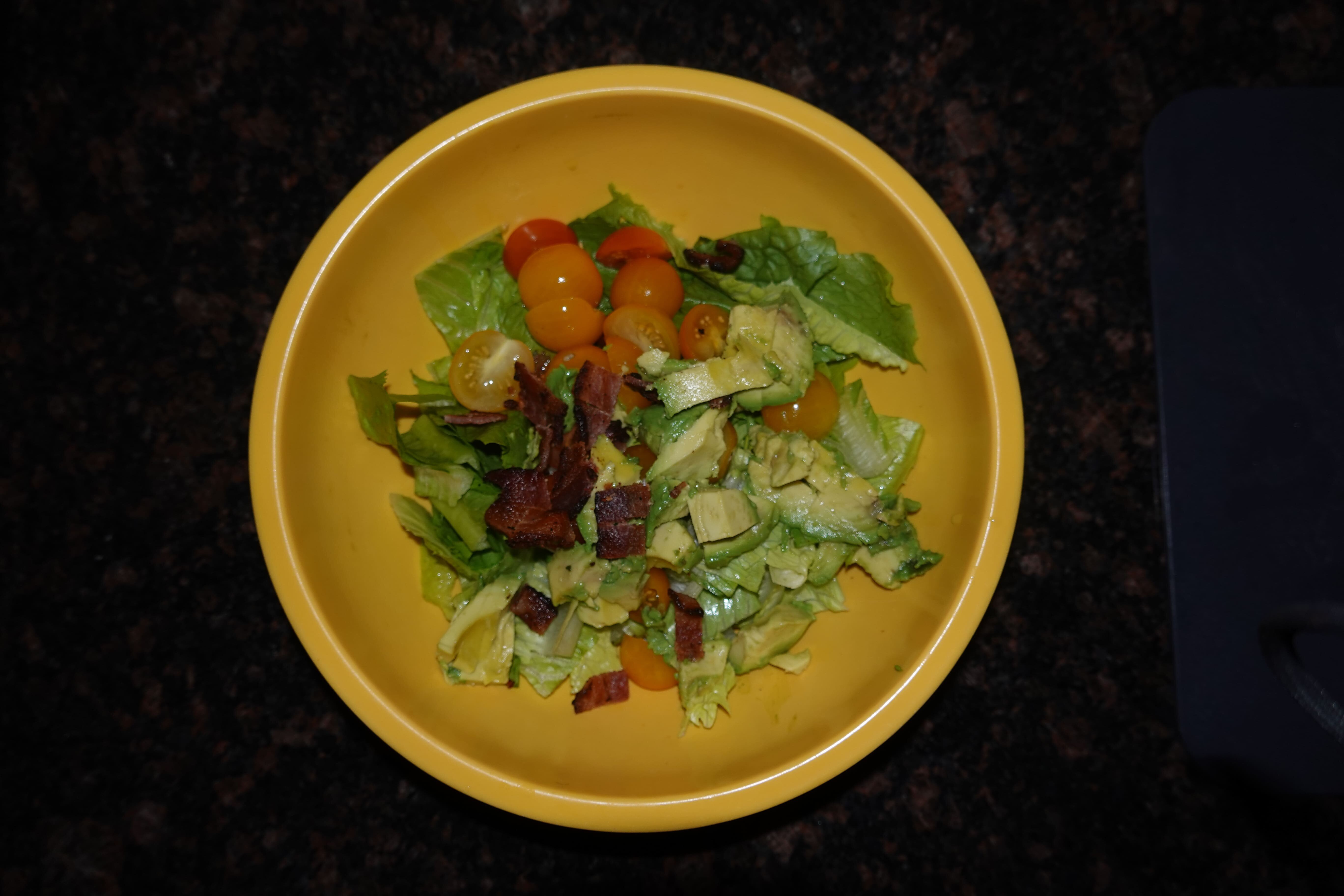 Salad with tomatoes, avocado, bacon, and tomatoes