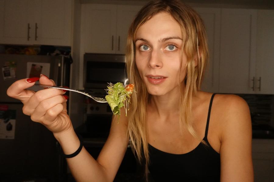 blonde girl eating a salad
